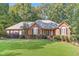 Ranch-style brick home with a well-manicured lawn at 4020 Brookwood Ter, Mcdonough, GA 30253