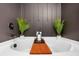 Soaking tub with wooden tray and decorative plants at 1958 Dillon Dr, Lithonia, GA 30058