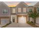 Two-story townhouse with attached garage and landscaping at 1958 Dillon Dr, Lithonia, GA 30058