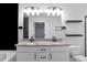 Double vanity bathroom with granite countertop and black matte fixtures at 1958 Dillon Dr, Lithonia, GA 30058