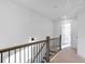 Upstairs hall with wood railing and carpet flooring at 1958 Dillon Dr, Lithonia, GA 30058