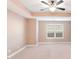 Spacious bedroom with carpeted floor, ceiling fan, and large window at 1958 Dillon Dr, Lithonia, GA 30058