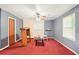 Living Room with red carpet, ceiling fan and two white chairs at 1955 Spink Nw St, Atlanta, GA 30318