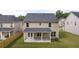 Two story house with backyard patio and fenced yard at 1898 Lacebark Elm Way, Lawrenceville, GA 30045
