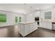 Modern kitchen with white cabinets, island and stainless steel appliances at 1898 Lacebark Elm Way, Lawrenceville, GA 30045