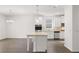 Modern kitchen with white cabinets, granite countertops and island at 1898 Lacebark Elm Way, Lawrenceville, GA 30045