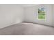Spacious bedroom featuring a large window and plush carpeting at 1898 Lacebark Elm Way, Lawrenceville, GA 30045