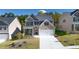 Two-story brick home with a two-car garage and landscaped lawn at 1898 Lacebark Elm Way, Lawrenceville, GA 30045