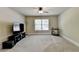 Bonus room with large TV, ceiling fan, and window at 3191 Lake Mcginnis Dr, Suwanee, GA 30024