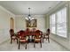 Formal dining room with hardwood floors, a large window, and chandelier at 3191 Lake Mcginnis Dr, Suwanee, GA 30024