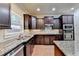 Kitchen features granite countertops and dark wood cabinets at 3191 Lake Mcginnis Dr, Suwanee, GA 30024