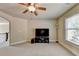 Bonus room with large TV, ceiling fan, and window at 3191 Lake Mcginnis Dr, Suwanee, GA 30024