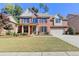 Brick house with a two-car garage and landscaping at 3191 Lake Mcginnis Dr, Suwanee, GA 30024