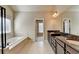 Bathroom boasts double vanity with granite countertop, large soaking tub, and separate shower at 3191 Lake Mcginnis Dr, Suwanee, GA 30024