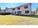 Home's backyard features a patio, grassy lawn, and mature trees at 3191 Lake Mcginnis Dr, Suwanee, GA 30024