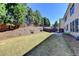 Home's backyard has a patio, grassy lawn, and a sloped yard with trees at 3191 Lake Mcginnis Dr, Suwanee, GA 30024