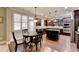 Kitchen boasts an island, breakfast nook, and dark wood cabinetry at 3191 Lake Mcginnis Dr, Suwanee, GA 30024