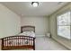 Cozy bedroom with a twin bed and window at 3191 Lake Mcginnis Dr, Suwanee, GA 30024