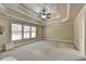 Spacious main bedroom with large window and tray ceiling at 3191 Lake Mcginnis Dr, Suwanee, GA 30024