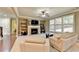 Open living room with a fireplace, seating area, and views of the kitchen at 3191 Lake Mcginnis Dr, Suwanee, GA 30024