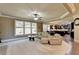 Relaxing living room with a fireplace, comfortable seating, and large windows at 3191 Lake Mcginnis Dr, Suwanee, GA 30024