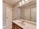 Bathroom with vanity, sink, and large mirror at 3191 Lake Mcginnis Dr, Suwanee, GA 30024