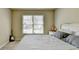 Spacious bedroom with large window and guitar at 3191 Lake Mcginnis Dr, Suwanee, GA 30024