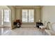 Sitting room with neutral walls, hardwood floors, and windows at 3191 Lake Mcginnis Dr, Suwanee, GA 30024