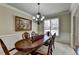 Spacious dining room, featuring a large table and chandelier at 3191 Lake Mcginnis Dr, Suwanee, GA 30024