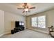 Bonus room with large TV, ceiling fan, and window at 3191 Lake Mcginnis Dr, Suwanee, GA 30024
