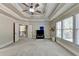 Spacious bedroom with a ceiling fan, large windows and access to a hallway at 3191 Lake Mcginnis Dr, Suwanee, GA 30024