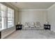 Sitting room with neutral walls, hardwood floors, and windows at 3191 Lake Mcginnis Dr, Suwanee, GA 30024