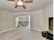 Bonus room with large TV, ceiling fan, and window at 3191 Lake Mcginnis Dr, Suwanee, GA 30024
