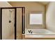 Relaxing bathroom with a soaking tub, shower, and a window for natural light at 3191 Lake Mcginnis Dr, Suwanee, GA 30024