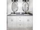 Double vanity bathroom with oval mirrors and white cabinets at 1696 Emerald Sw Ave, Atlanta, GA 30310