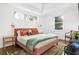 Spacious bedroom with a king-size bed, two windows, and unique decor at 1696 Emerald Sw Ave, Atlanta, GA 30310