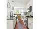 Modern kitchen with white cabinets, stainless steel appliances and an island at 1696 Emerald Sw Ave, Atlanta, GA 30310