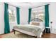 Bright bedroom with a king-size bed and teal curtains at 1696 Emerald Sw Ave, Atlanta, GA 30310