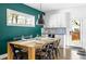 Bright dining area with a long wooden table and black metal chairs at 1696 Emerald Sw Ave, Atlanta, GA 30310