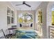 Inviting front porch with swing, brick columns, and a tropical-print rug at 1696 Emerald Sw Ave, Atlanta, GA 30310