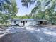 Rear view of a renovated white house with new siding and a gravel driveway at 198 Oak Hill Cir, Canton, GA 30114