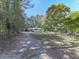 White house with black shutters and a covered carport, nestled among lush green trees at 198 Oak Hill Cir, Canton, GA 30114