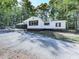 Front view of a charming white house with a carport and a partially visible driveway at 198 Oak Hill Cir, Canton, GA 30114