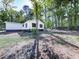 Side view of a white house with dark brown accents and a large yard at 198 Oak Hill Cir, Canton, GA 30114