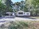 Front view of a renovated white house with black accents and a large yard at 198 Oak Hill Cir, Canton, GA 30114