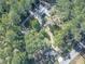 Home nestled in a wooded area with a long driveway and nearby road at 198 Oak Hill Cir, Canton, GA 30114
