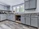 Efficient kitchen featuring gray cabinets, granite countertops, and built-in microwave at 198 Oak Hill Cir, Canton, GA 30114