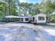 Newly renovated white house with black accents and a metal roof at 198 Oak Hill Cir, Canton, GA 30114