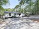 Rear view of a white house with a gravel driveway and trees at 198 Oak Hill Cir, Canton, GA 30114