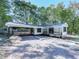 Front view of a charming white house with black accents and carport at 198 Oak Hill Cir, Canton, GA 30114